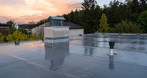 a rubber flat roof installed around chimneys in sunset suburbs.